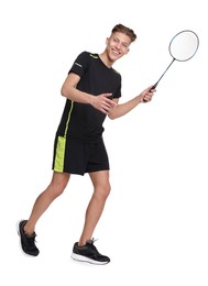 Young man playing badminton with racket on white background