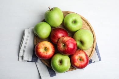 Photo of Different sweet apples on white wooden table, top view