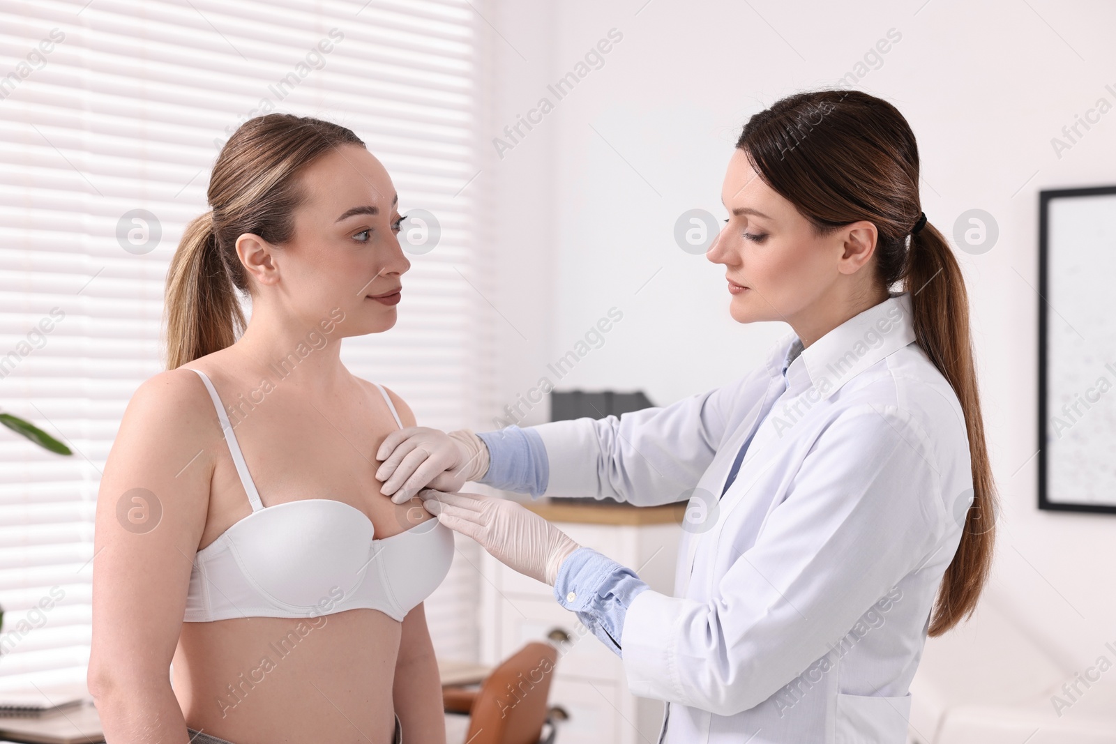 Photo of Mammologist checking young woman's breast in hospital