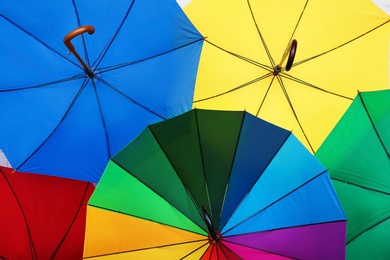 Many stylish colorful umbrellas as background, closeup