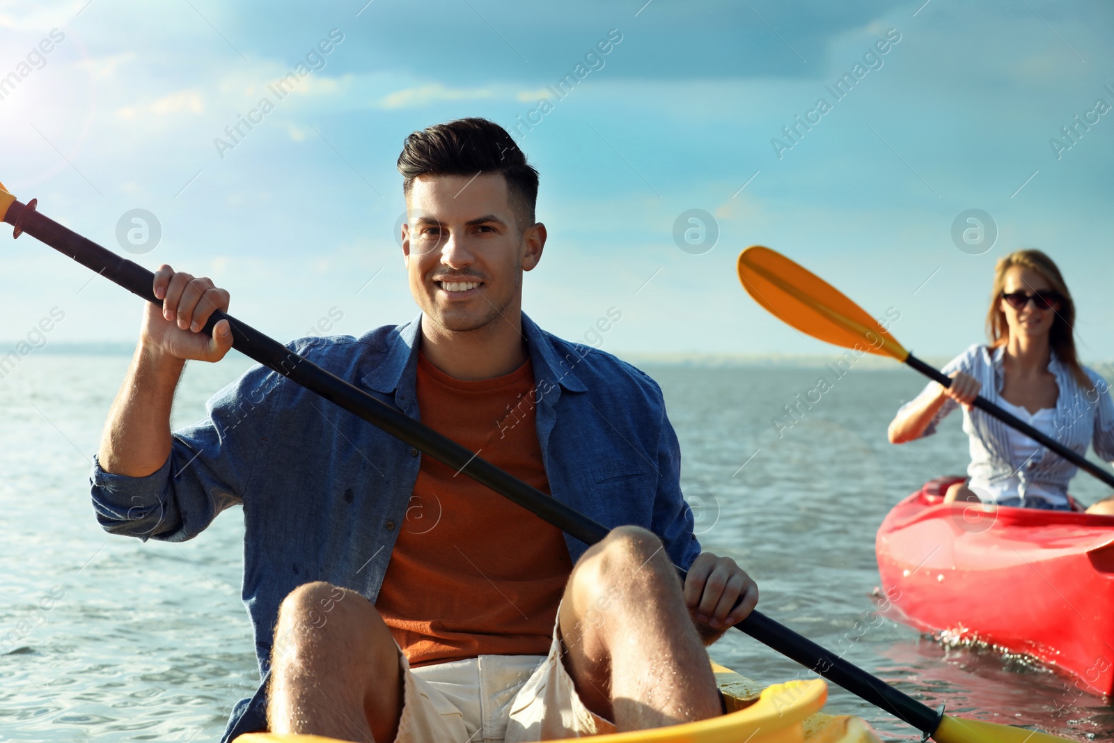 Photo of Happy couple kayaking on river. Summer activity