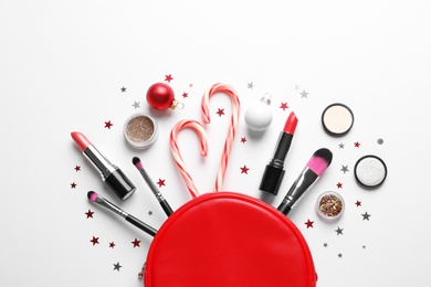 Flat lay composition with makeup products and Christmas decor on white background