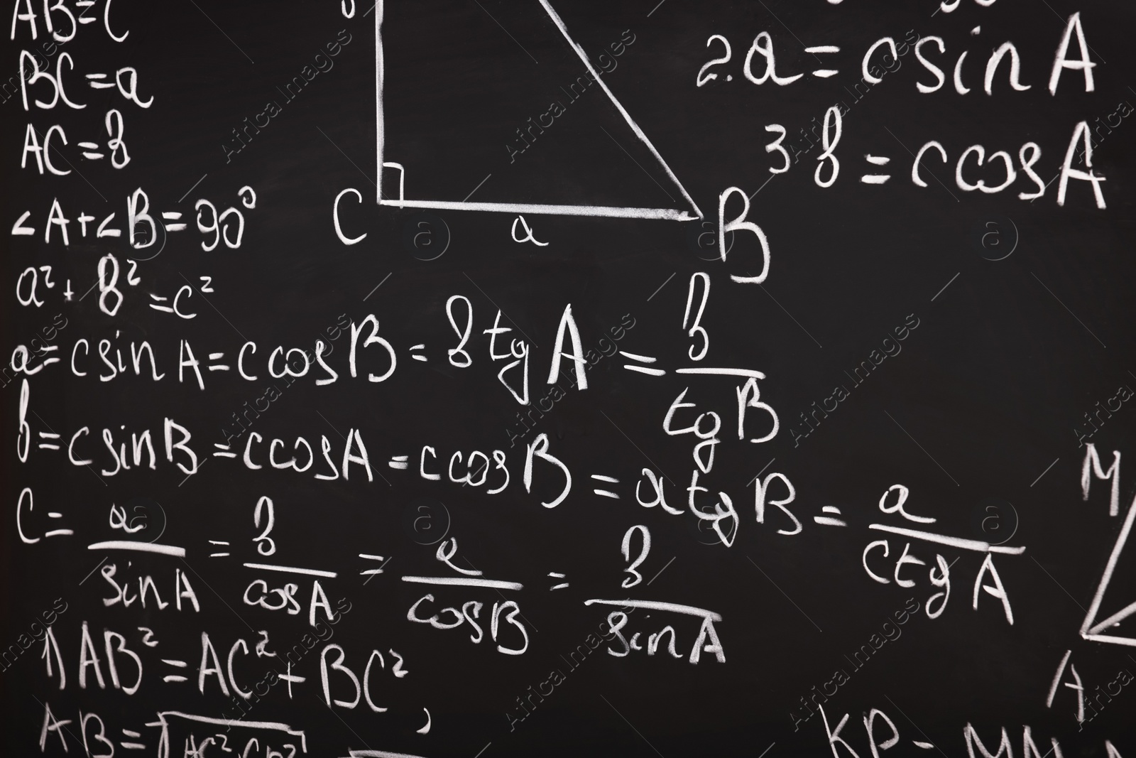 Photo of Different mathematical formulas written with chalk on blackboard