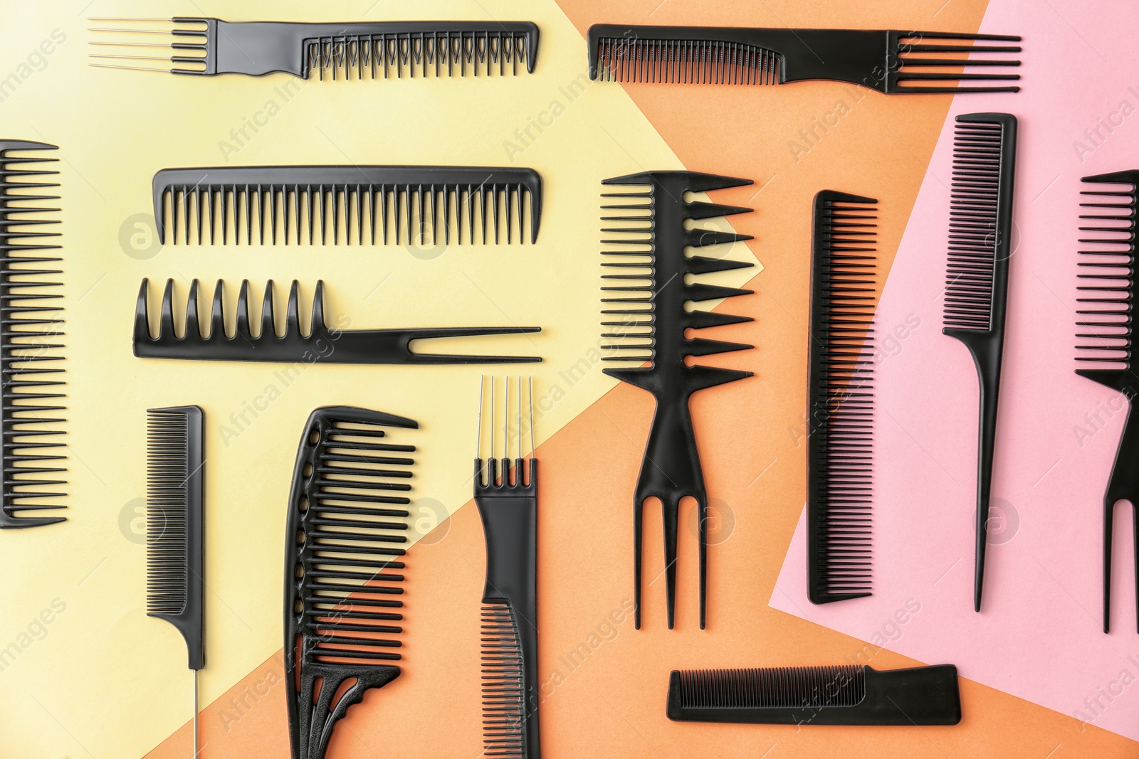 Photo of Flat lay composition with professional hairdresser tools on color background