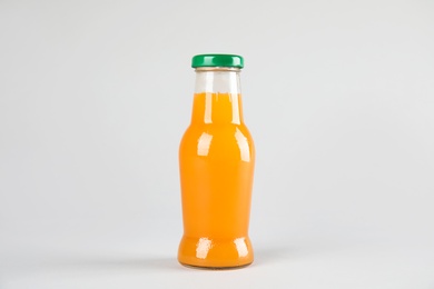 Photo of One bottle with tasty drink on color background