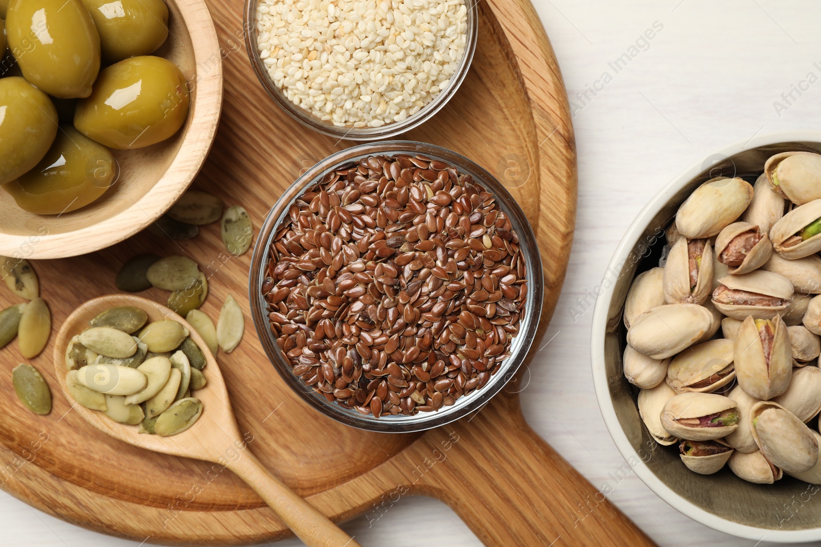 Photo of Different products high in vegetable fats on white wooden table, flat lay