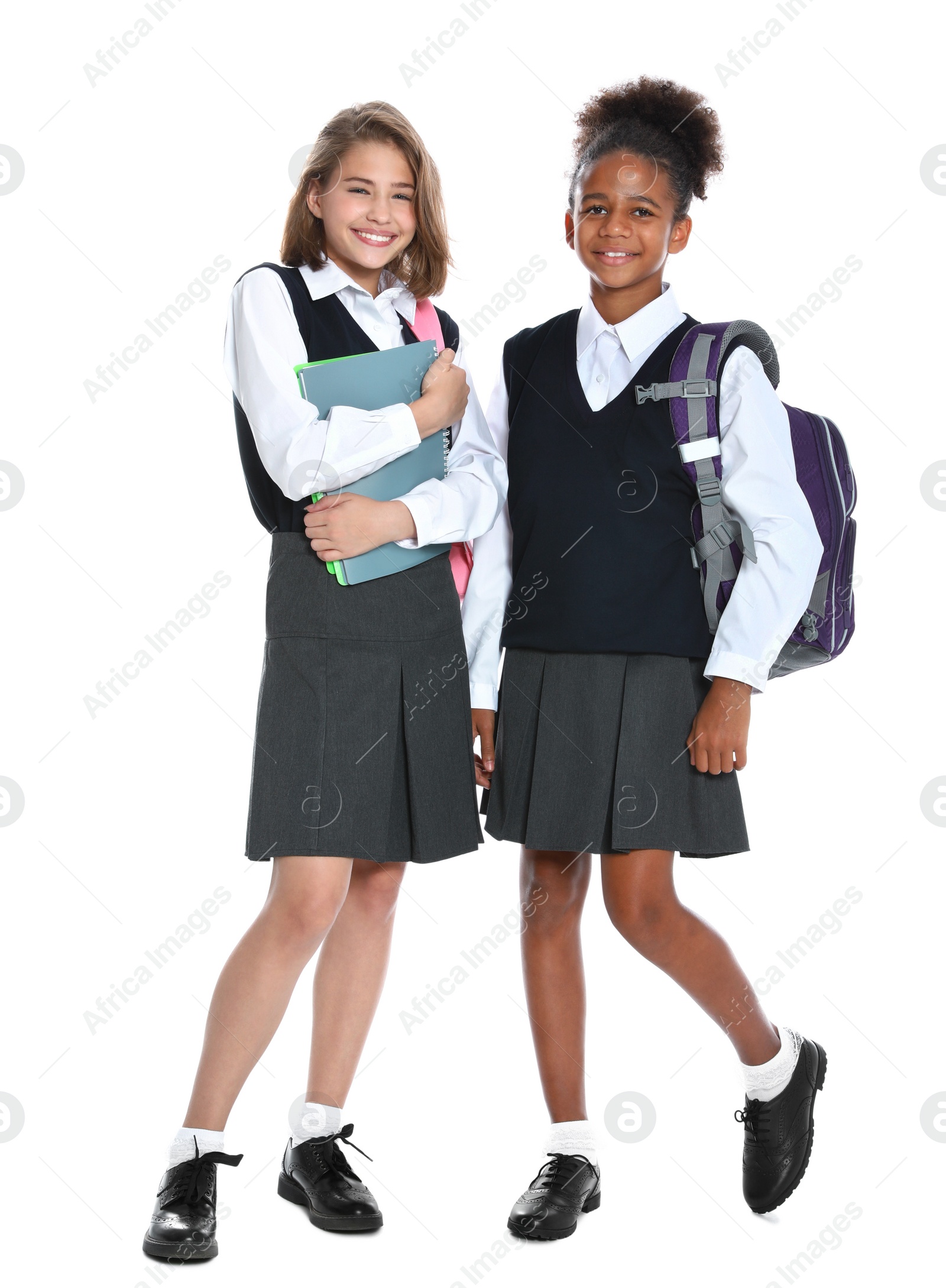 Photo of Happy girls in school uniform on white background