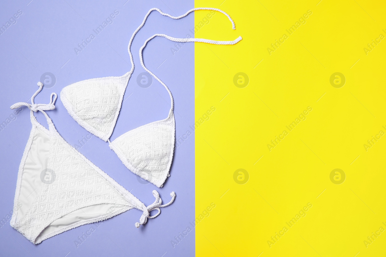 Photo of Stylish bikini on color background, flat lay. Space for text