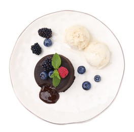 Photo of Plate with delicious chocolate fondant, berries, mint and ice cream isolated on white, top view