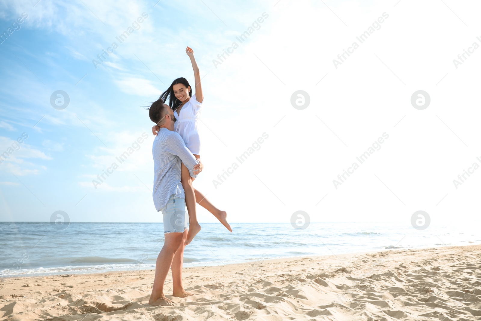 Photo of Happy young couple having fun on beach