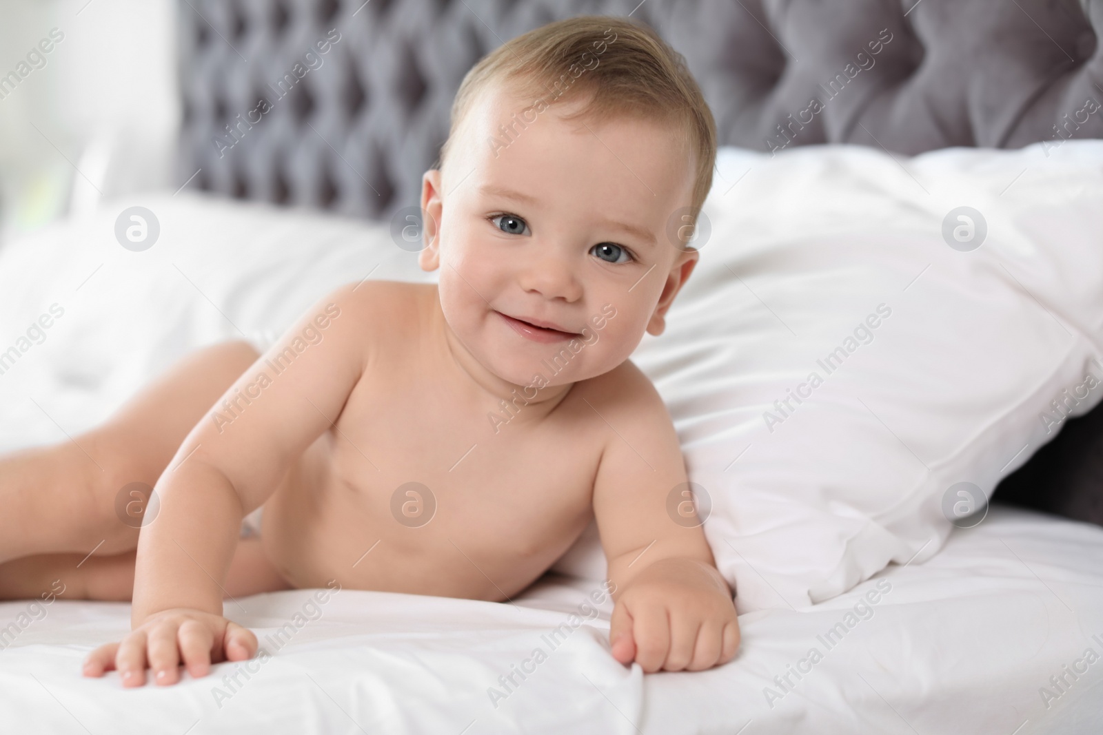 Photo of Adorable little baby on bed at home