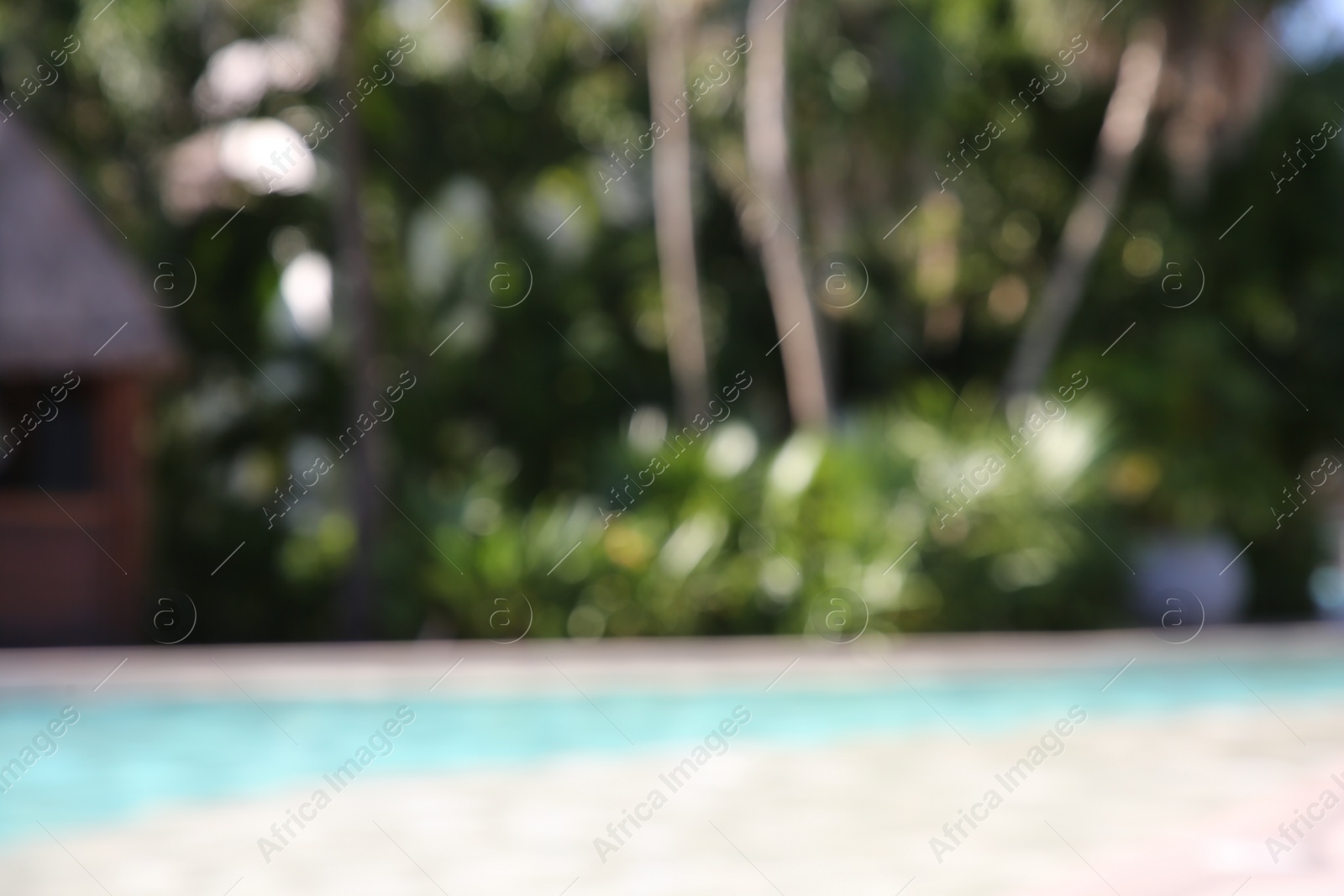 Photo of Blurred view of outdoor swimming pool at resort on sunny day