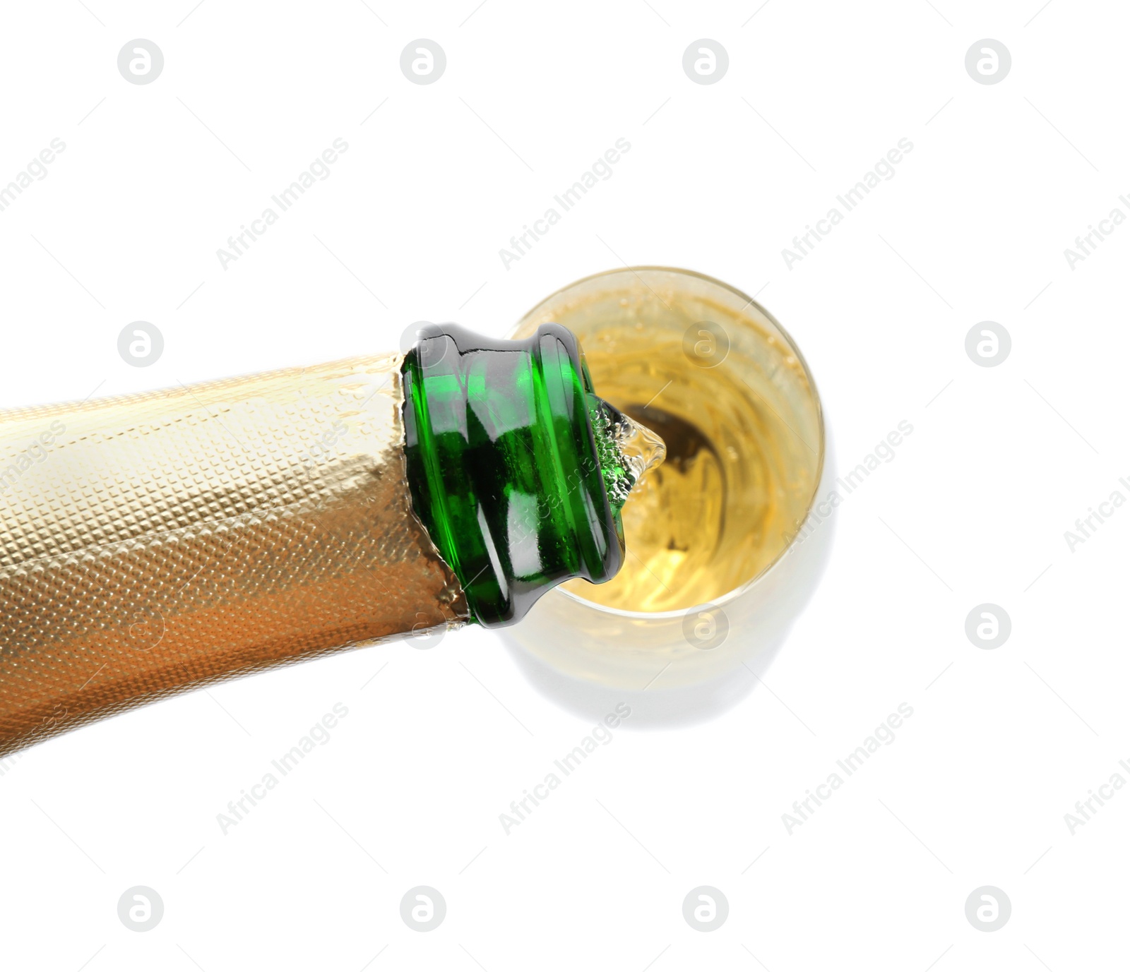 Photo of Pouring champagne from bottle into glass on white background, top view. Festive drink