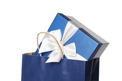 Blue paper shopping bag with gift box on white background