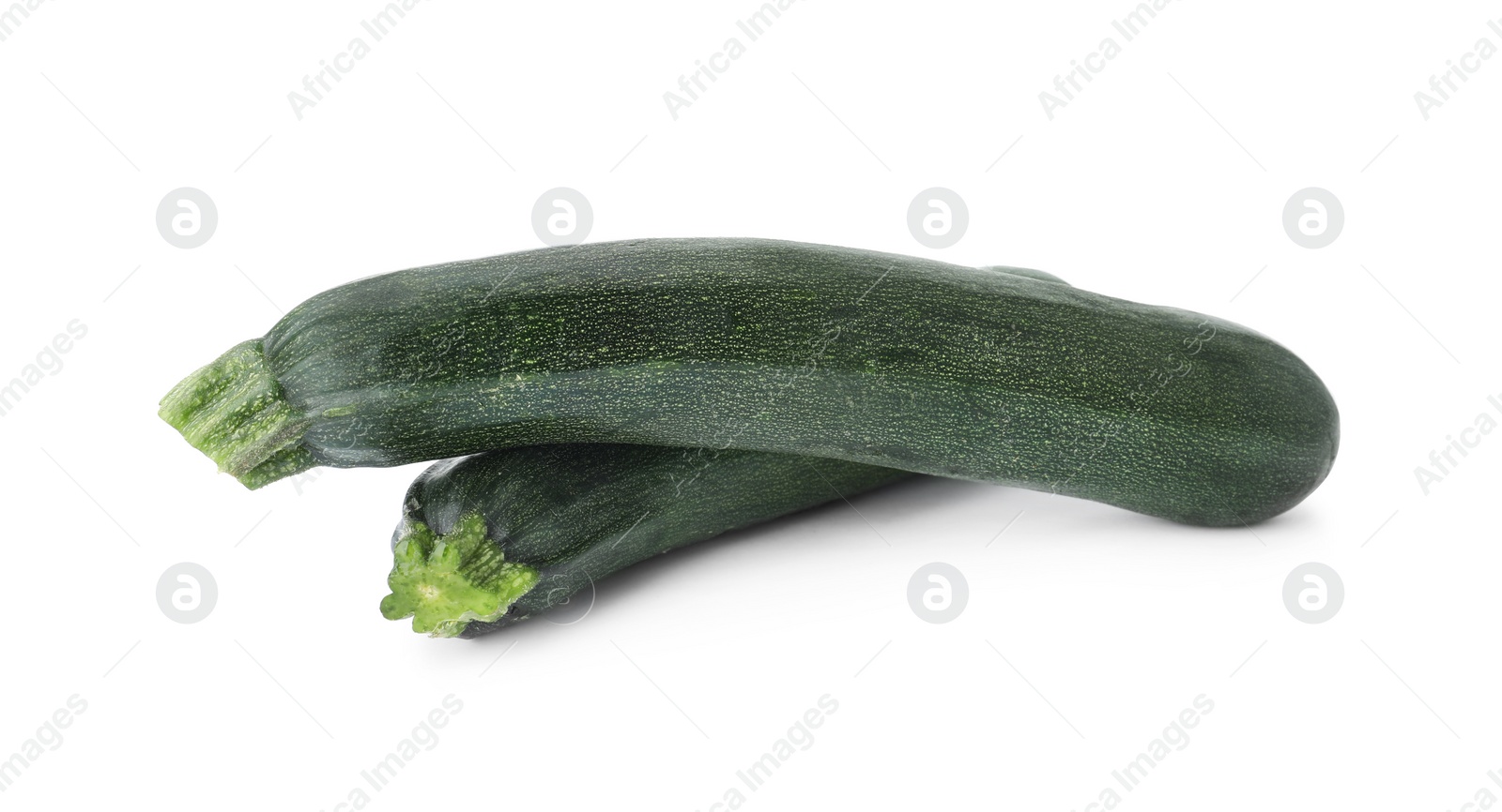 Photo of Raw green ripe zucchinis isolated on white