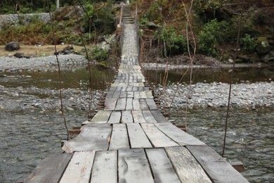 Photo of Beautiful view on wooden bridge over river in mountains