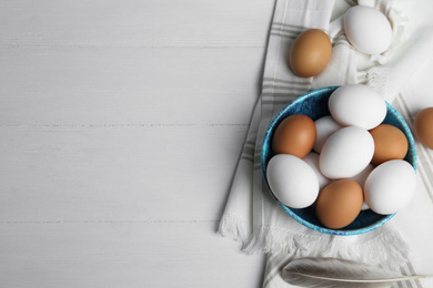 Photo of Flat lay composition with raw chicken eggs on white wooden table. Space for text