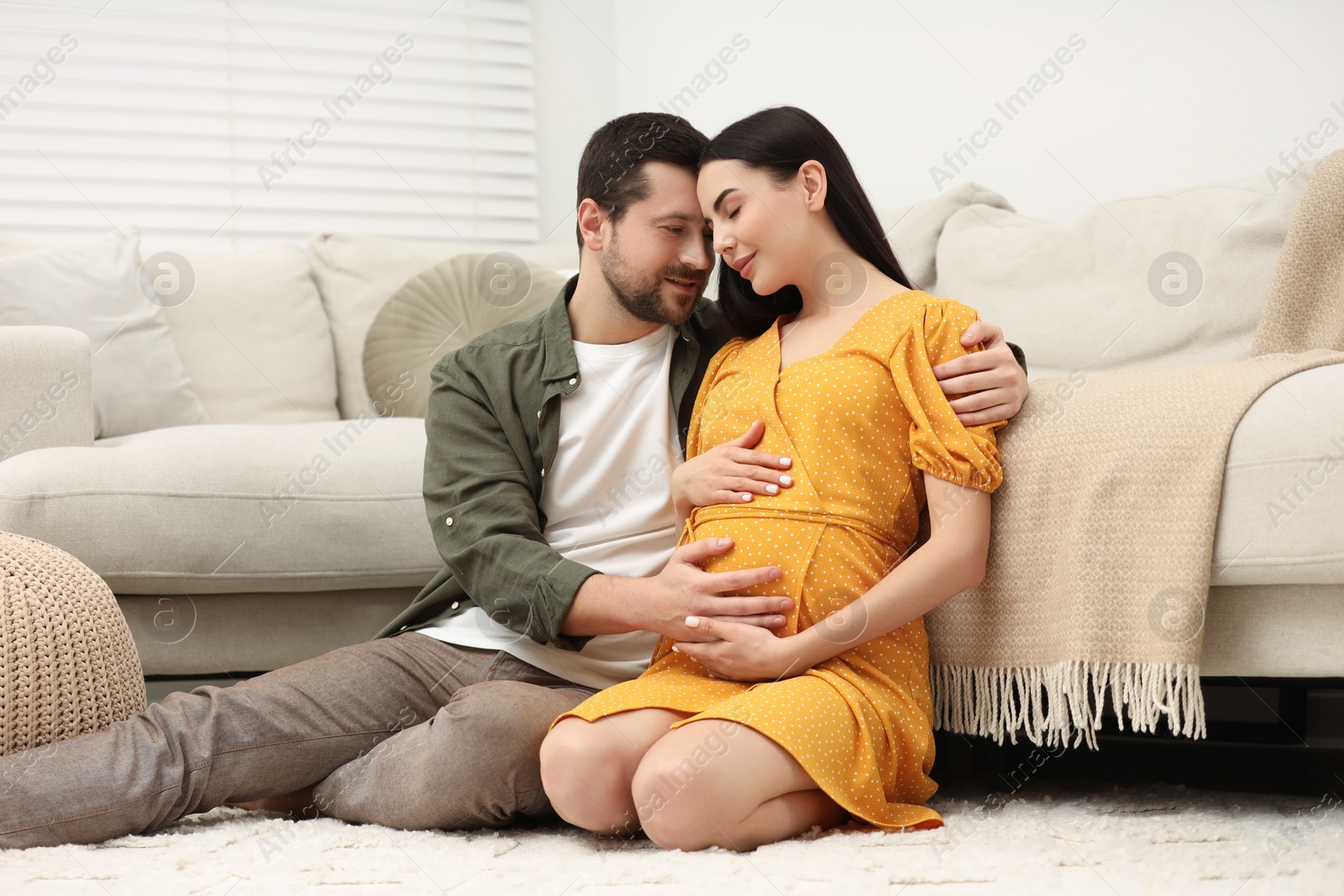 Photo of Pregnant woman with her husband at home