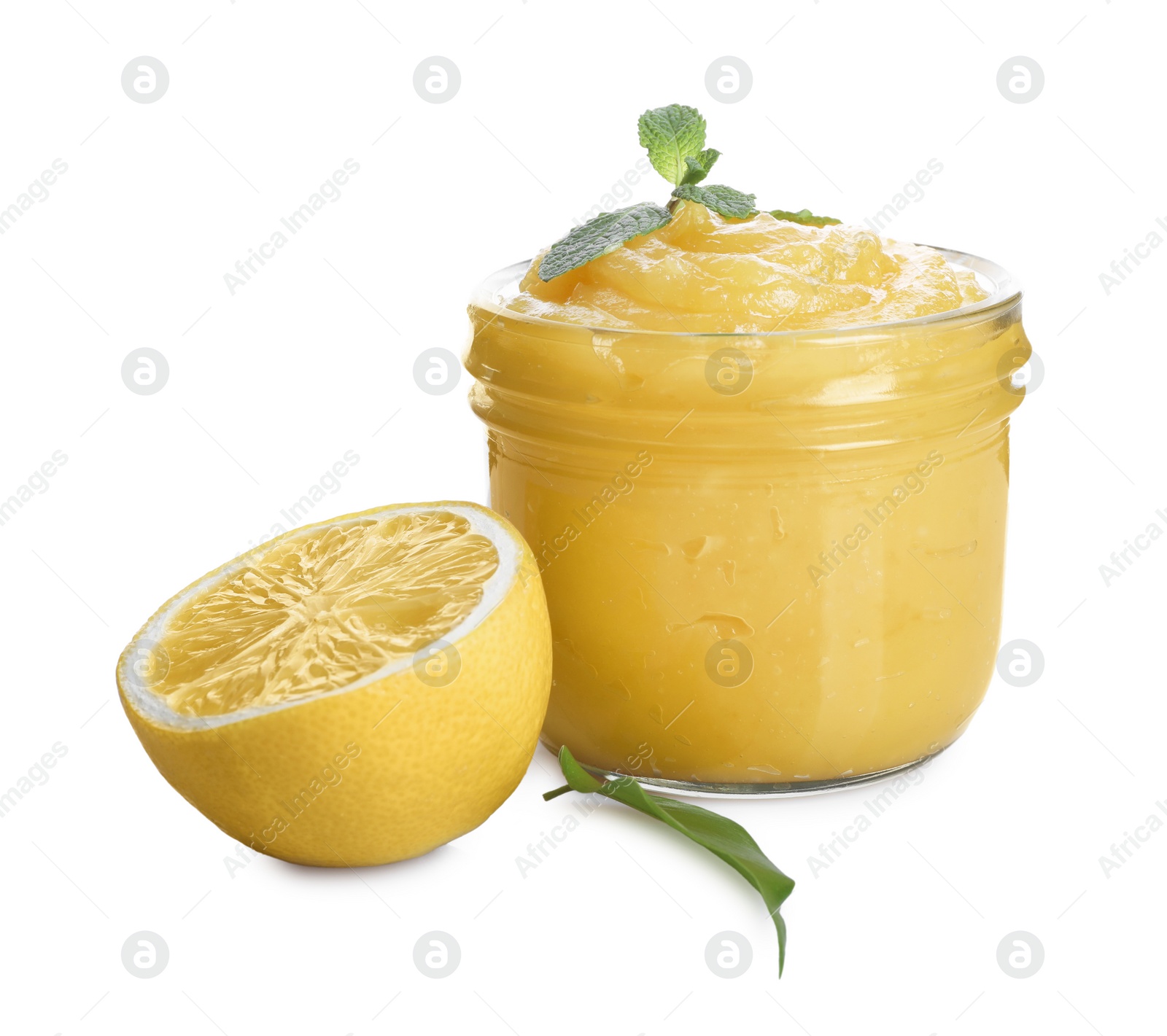 Photo of Delicious lemon curd in glass jar, fresh citrus fruit, mint and green leaf isolated on white