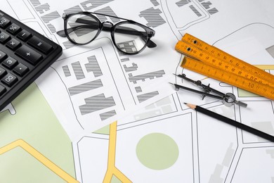 Photo of Office stationery on cadastral maps of territory with buildings