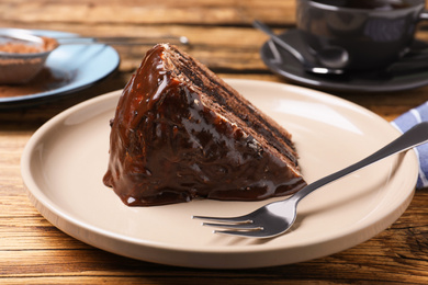 Photo of Delicious chocolate cake on wooden table, closeup