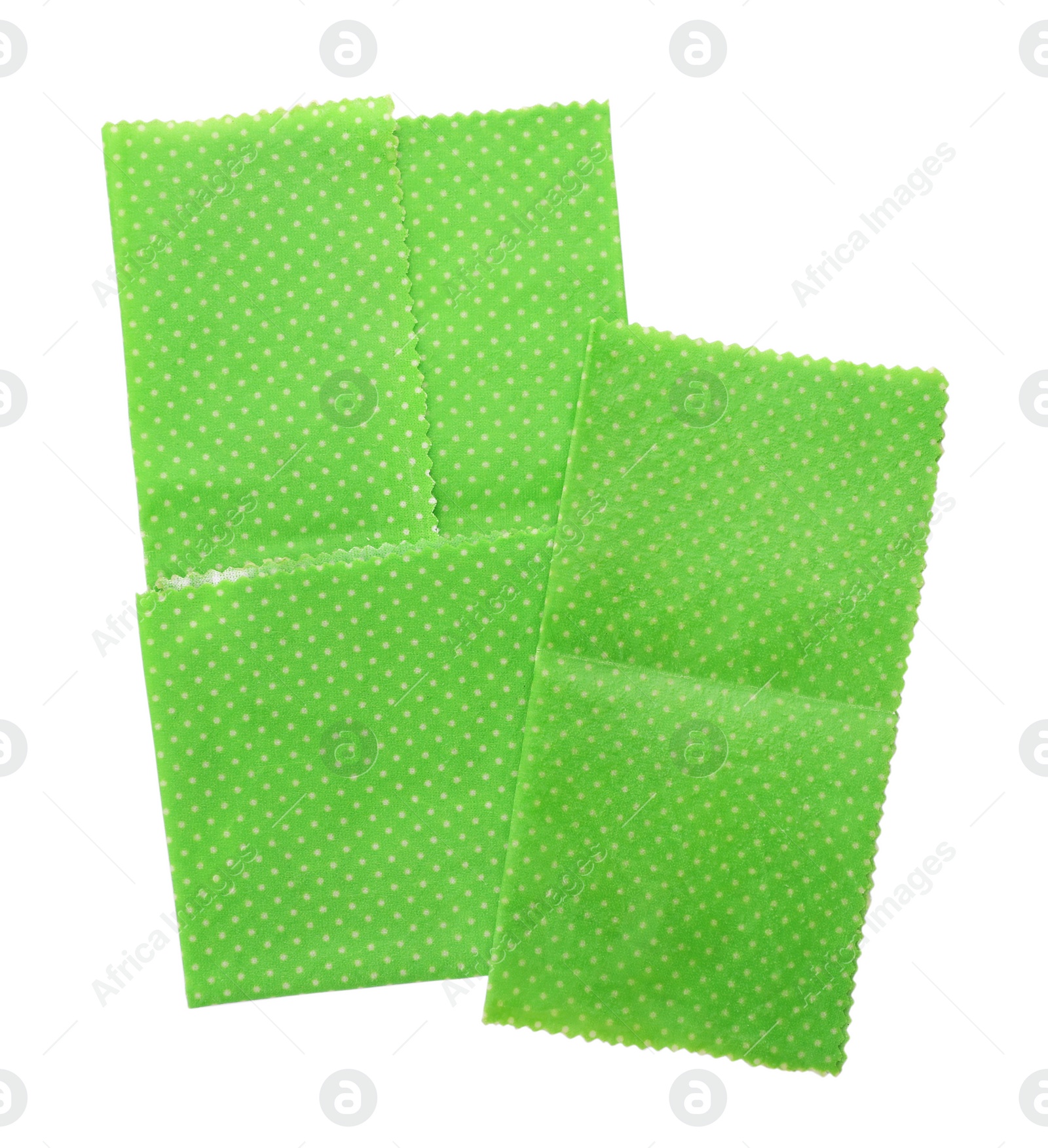 Photo of Green reusable beeswax food wraps on white background, top view