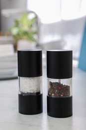 Salt and pepper shakers on white table
