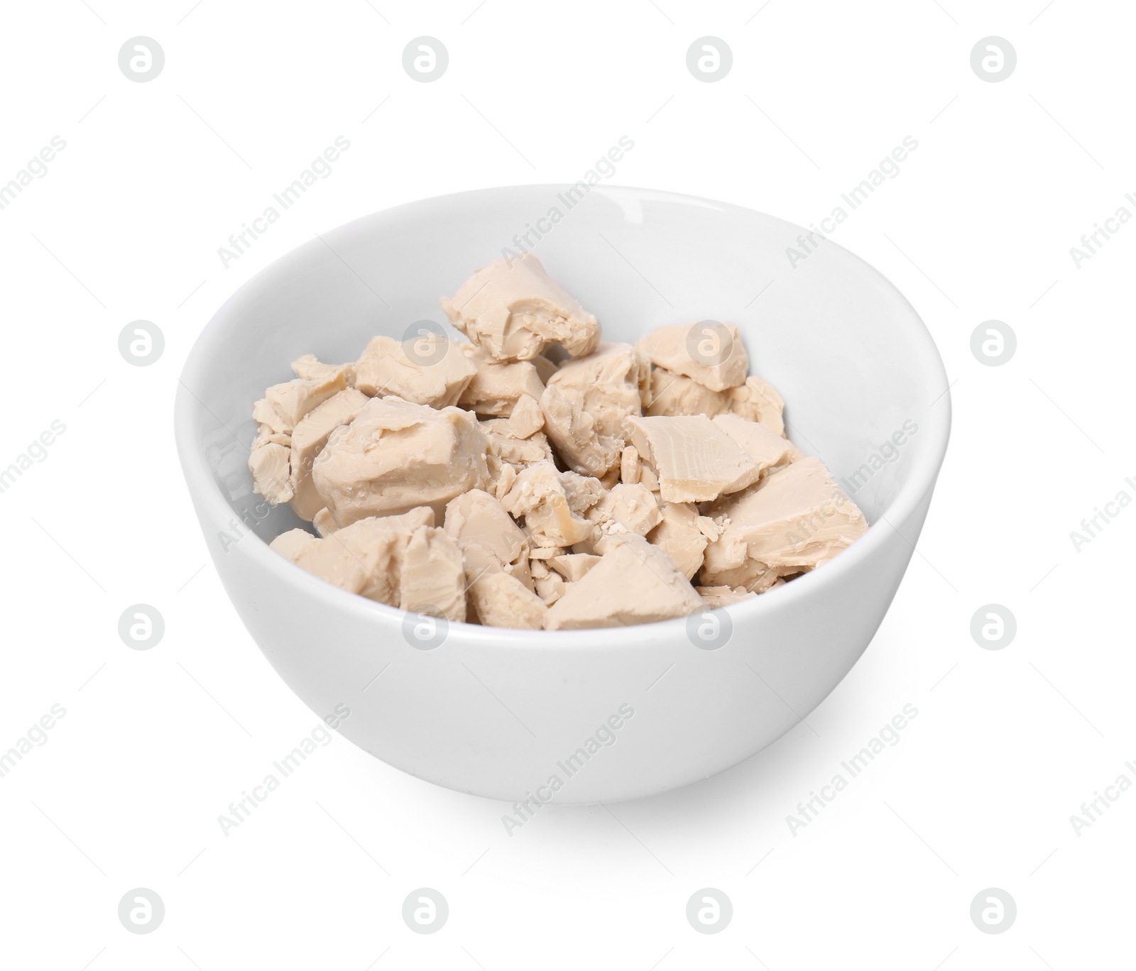 Photo of Pieces of compressed yeast in bowl isolated on white