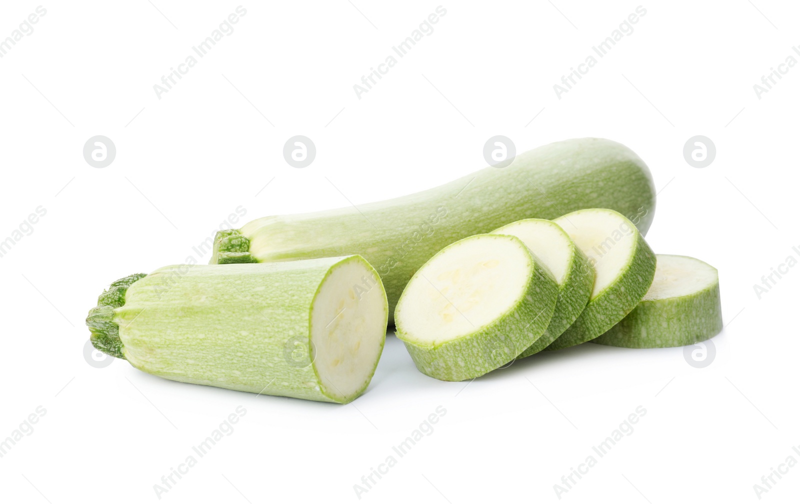 Photo of Cut and whole green ripe zucchinis on white background