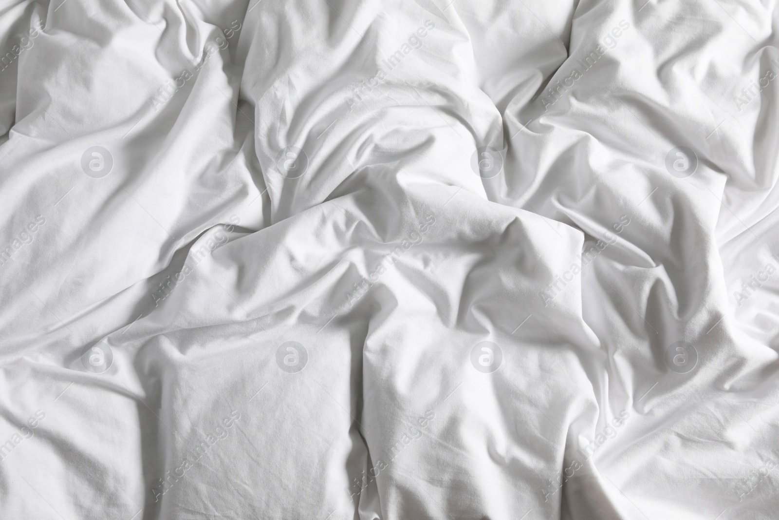 Photo of Crumpled white fabric as background, closeup view