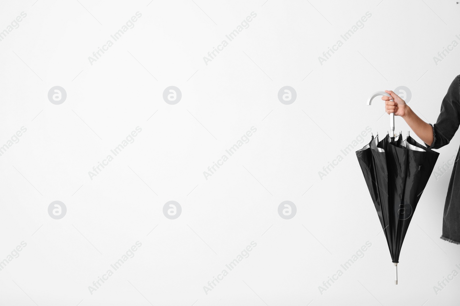 Photo of Person holding umbrella on white background with space for design