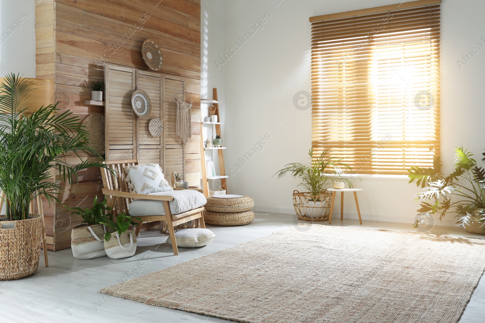 Photo of Stylish living room interior with comfortable wooden armchair and beautiful houseplants