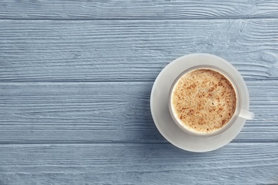 Photo of Cup of aromatic hot coffee on wooden background, top view