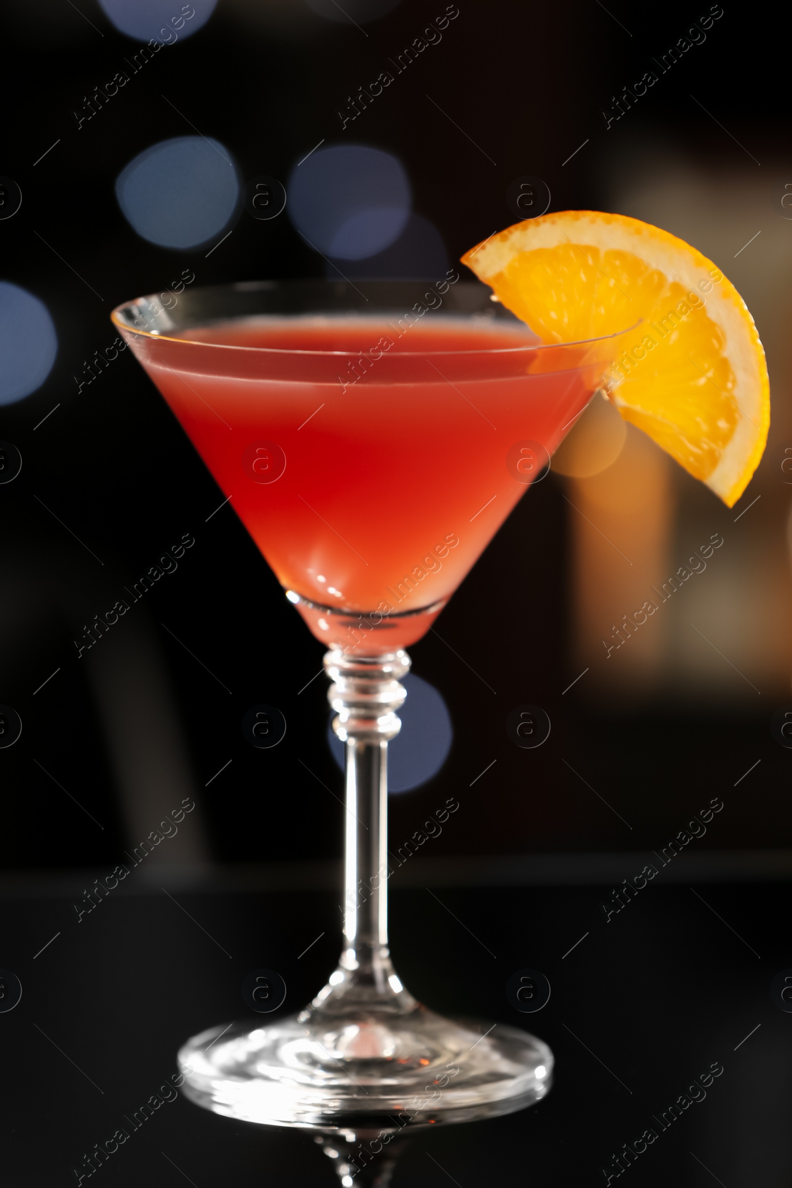 Photo of Delicious cocktail with orange on bar counter