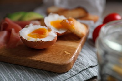 Photo of Delicious breakfast with soft boiled egg on table