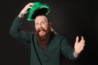 Photo of Bearded man with green hat on black background. St. Patrick's Day celebration