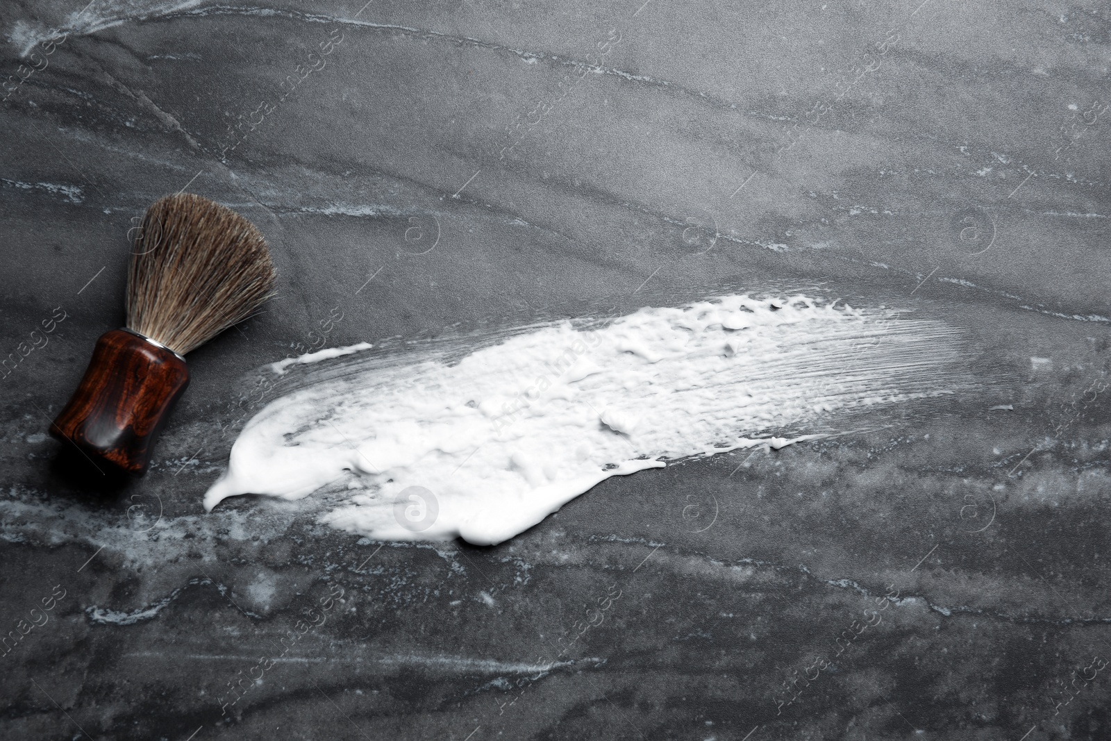 Photo of Flat lay composition with shaving brush and foam stroke on gray background