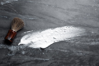 Flat lay composition with shaving brush and foam stroke on gray background