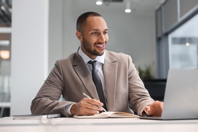 Happy man working at table in office. Lawyer, businessman, accountant or manager
