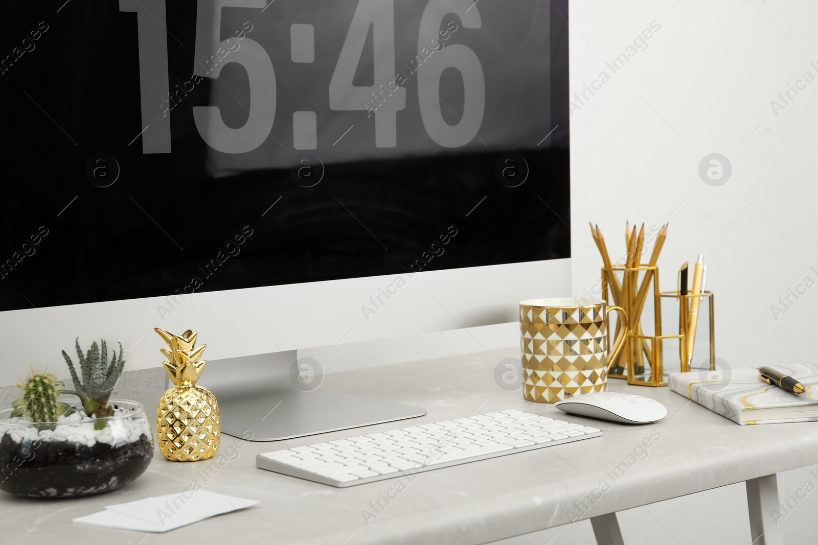 Photo of Stylish workplace with different golden accessories indoors. Idea for interior design