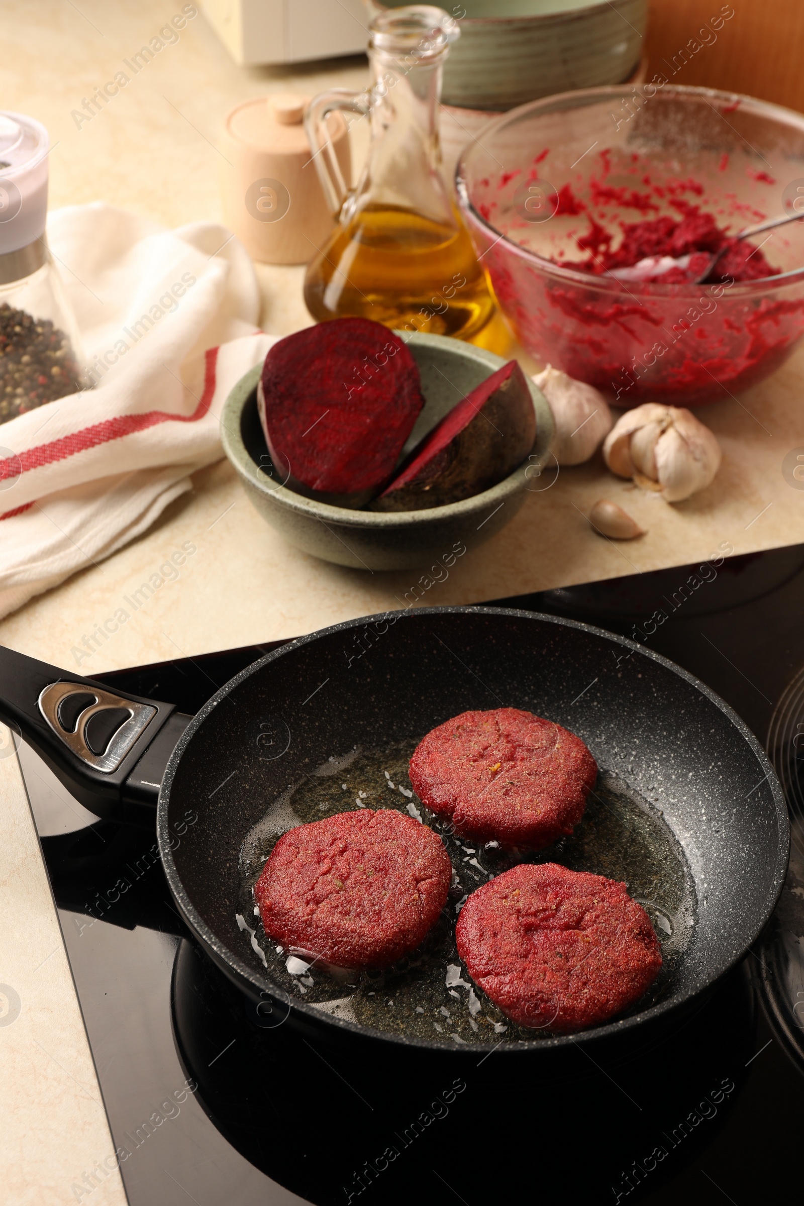 Photo of Cooking vegan cutlets in frying pan on stove