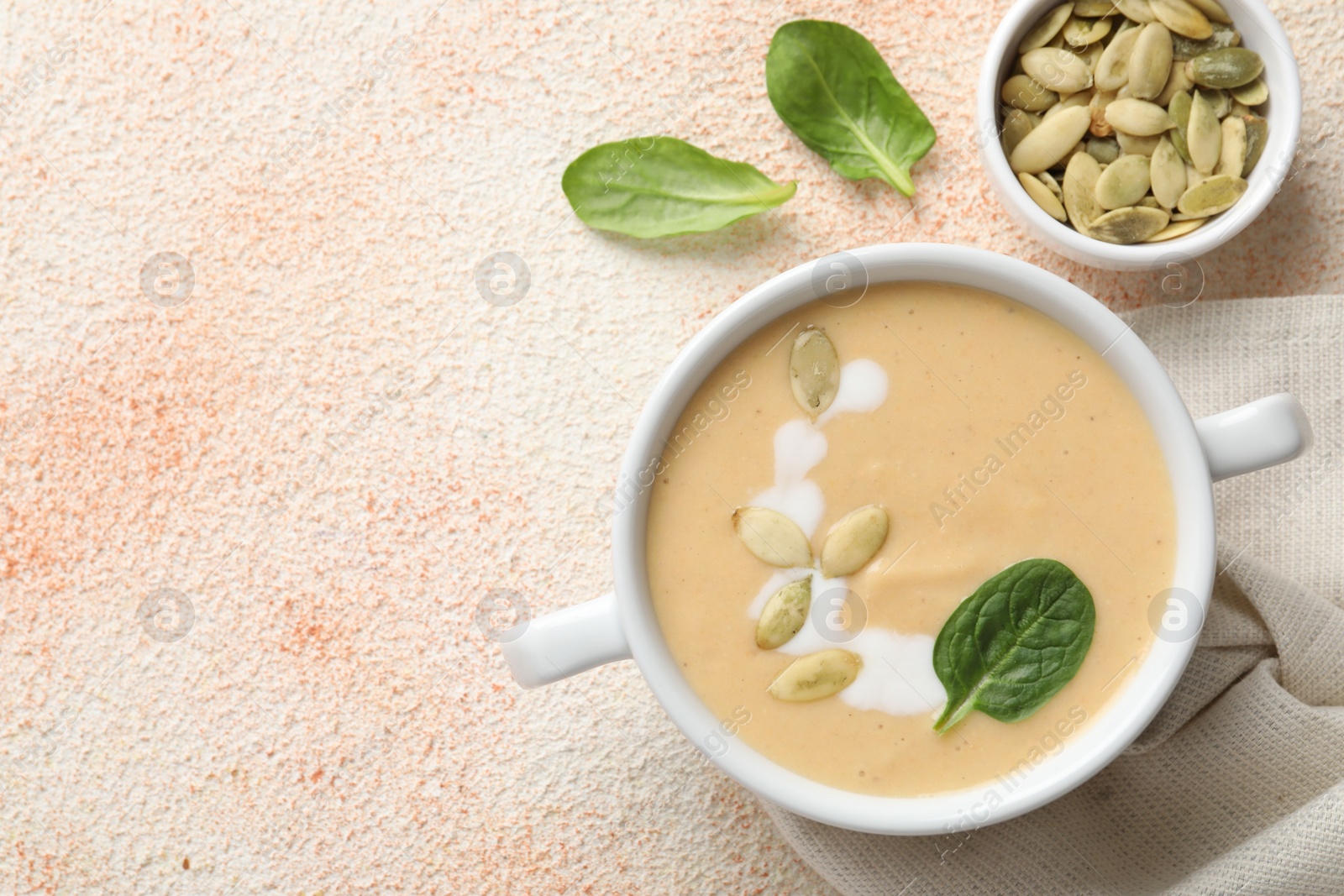 Photo of Healthy cream soup high in vegetable fats on color textured table, flat lay. Space for text