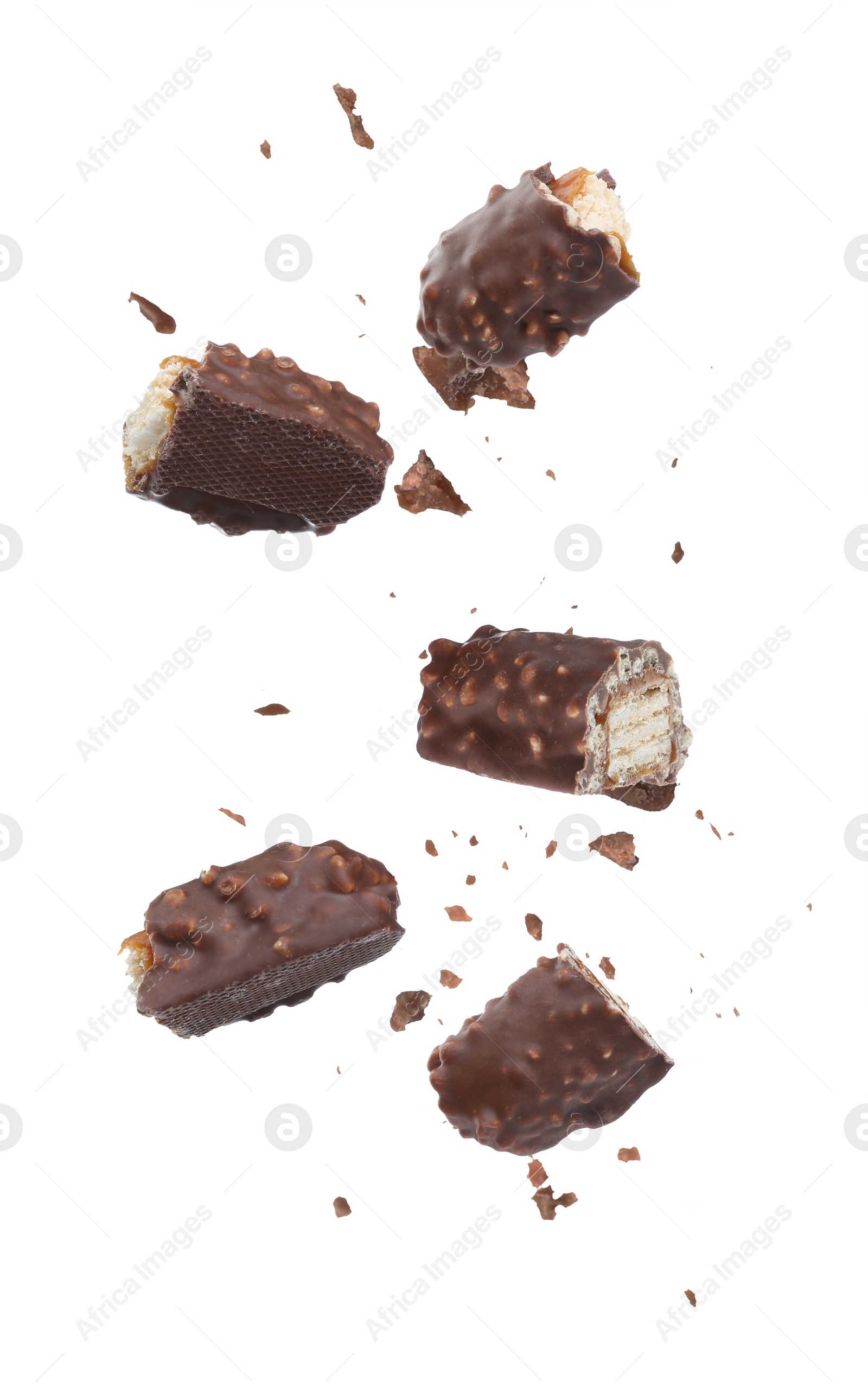 Image of Pieces of chocolate bars falling on white background