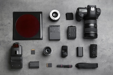 Flat lay composition with photographer's equipment and accessories on grey background