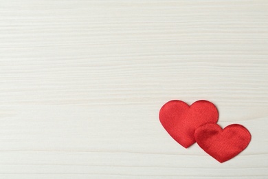 Photo of Decorative hearts on white wooden table, flat lay with space for text. Valentine's day