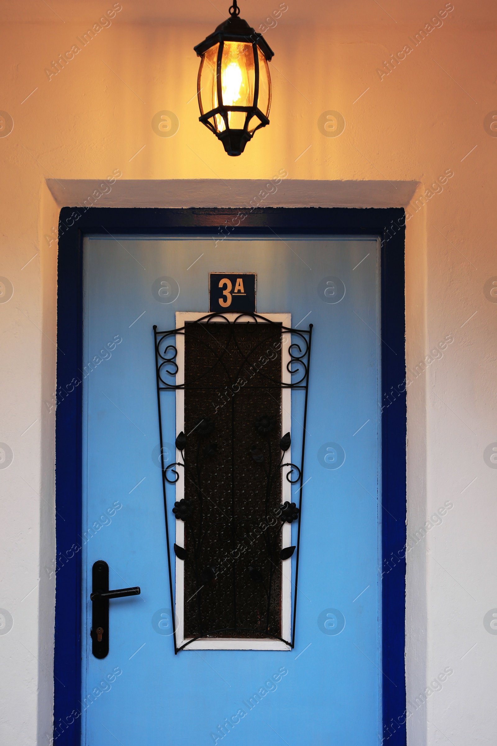 Photo of Plate with house number three on stylish door