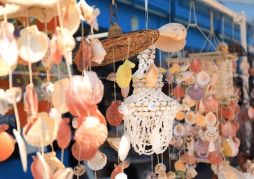 Photo of Wind chimes made of sea shells in outdoor souvenir shop