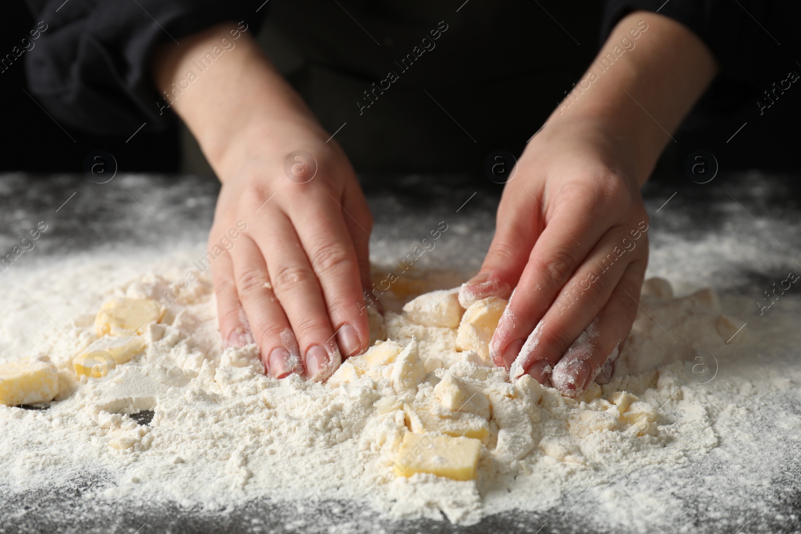 Photo of Woman making shortcrust pastry at table, closeup