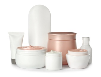 Different containers with hand cream and other cosmetic on white background