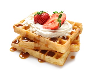 Photo of Yummy waffles with whipped cream, strawberries and caramel syrup on white background